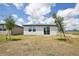 Backyard view of the house, showing well-maintained grass and nearby properties at 4010 Copperleaf Ln, Poinciana, FL 34759