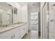 This bathroom has a double vanity with stone countertops and a glass-enclosed shower at 4010 Copperleaf Ln, Poinciana, FL 34759