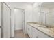 This bathroom has a double vanity with stone countertops and a large glass-enclosed shower at 4010 Copperleaf Ln, Poinciana, FL 34759