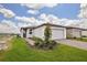 Inviting single-story home with a two-car garage and a freshly landscaped front yard at 4010 Copperleaf Ln, Poinciana, FL 34759
