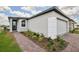 Attractive single-story home with brick walkway, fresh landscaping and two-car garage at 4010 Copperleaf Ln, Poinciana, FL 34759