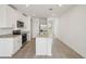 Bright kitchen with white cabinetry, granite counters, stainless steel appliances, and a large island at 4010 Copperleaf Ln, Poinciana, FL 34759