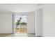 Bright living room with tile floors and a sliding glass door offering backyard lake views at 4010 Copperleaf Ln, Poinciana, FL 34759