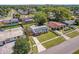 Aerial view of neighborhood with mature trees and the home with solar panels on roof at 4127 Sanseviera Ln, Orlando, FL 32822