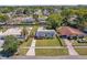 Aerial view of home and neighborhood showcasing solar panels and well-maintained lawn at 4127 Sanseviera Ln, Orlando, FL 32822