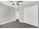 This bedroom features neutral walls, a ceiling fan, closet, and ensuite bathroom at 4127 Sanseviera Ln, Orlando, FL 32822