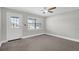 Bright bedroom with neutral walls, carpeted floor, ceiling fan, and a door to the outside at 4127 Sanseviera Ln, Orlando, FL 32822