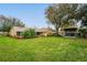 View of the house from the yard featuring well-manicured lawn and landscaping at 4442 Glenview Ln, Winter Park, FL 32792