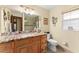 Bathroom featuring granite countertops, wood cabinets, and a decorative mirror at 4442 Glenview Ln, Winter Park, FL 32792