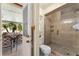 Well-lit bathroom with a glass shower enclosure, and an exit to a screened in porch at 4442 Glenview Ln, Winter Park, FL 32792