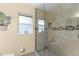 Modern bathroom with glass shower and tiled walls with decorative accent at 4442 Glenview Ln, Winter Park, FL 32792