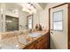 Bathroom featuring a granite countertop vanity with natural light and access to the screened porch at 4442 Glenview Ln, Winter Park, FL 32792