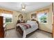 Cozy bedroom with neutral carpet, wooden furniture, and bright floral curtains at 4442 Glenview Ln, Winter Park, FL 32792