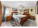 Spacious bedroom featuring an ornate wood bed frame, a ceiling fan, and tile flooring at 4442 Glenview Ln, Winter Park, FL 32792