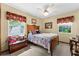 Cozy bedroom with a wooden bed frame, a ceiling fan, and bright natural light at 4442 Glenview Ln, Winter Park, FL 32792