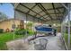 Covered carport featuring boat parking with a Lund boat, metal structure, and chairs on the concrete floor at 4442 Glenview Ln, Winter Park, FL 32792