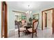 Cozy dining area with glass top table, chandelier, and sliding glass doors to the patio at 4442 Glenview Ln, Winter Park, FL 32792