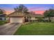 Sunset view of a charming single-Gathering home with a brick-accented facade and well-manicured front lawn at 4442 Glenview Ln, Winter Park, FL 32792