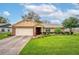 Charming single-Gathering home featuring well-manicured landscaping and a brick-accented facade with attached garage at 4442 Glenview Ln, Winter Park, FL 32792