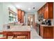 Bright kitchen with granite counters, stainless appliances, and wood cabinets next to breakfast bar at 4442 Glenview Ln, Winter Park, FL 32792