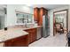 Well-lit kitchen with granite countertops, stainless steel appliances, and wood cabinets at 4442 Glenview Ln, Winter Park, FL 32792