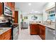 Well-lit kitchen with stainless steel appliances, granite counters and an open view to the living space at 4442 Glenview Ln, Winter Park, FL 32792