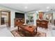 Bright living room with sliding doors, a view of the kitchen, and hardwood floors at 4442 Glenview Ln, Winter Park, FL 32792