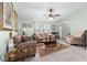 Light-filled living room with tile floors, comfortable seating, and view to dining area at 4442 Glenview Ln, Winter Park, FL 32792