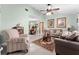 Comfortable living room with tile flooring, ceiling fan, neutral decor, and a view of the adjacent dining area at 4442 Glenview Ln, Winter Park, FL 32792