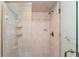 Modern tiled shower with glass door, and built-in shelving for bath supplies at 4442 Glenview Ln, Winter Park, FL 32792