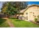 Side yard of home featuring lush lawn, privacy fence, and an exterior door at 4442 Glenview Ln, Winter Park, FL 32792