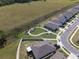 Aerial view of homes in a planned community near a green space at 447 Talisi Loop, St Cloud, FL 34771