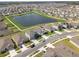 High angle shot of the community homes surrounding a large neighborhood pond at 447 Talisi Loop, St Cloud, FL 34771