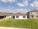 A view of the backyard with lush green grass and a home's rear exterior at 447 Talisi Loop, St Cloud, FL 34771