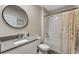 Well-lit bathroom featuring a vanity with a modern mirror, a toilet, and a shower/tub combo at 447 Talisi Loop, St Cloud, FL 34771