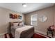 Comfortable bedroom featuring a gray bed, decorative pillows, and a cozy ambiance at 447 Talisi Loop, St Cloud, FL 34771