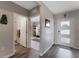 Welcoming foyer with wood-look flooring, white doors, and neutral paint at 447 Talisi Loop, St Cloud, FL 34771