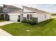 Beautiful front exterior featuring stone accents, a modern roof line and a well maintained lawn at 447 Talisi Loop, St Cloud, FL 34771