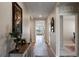 Bright hallway features wood flooring, a decorative table and an art piece at 447 Talisi Loop, St Cloud, FL 34771