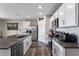 Bright kitchen view with stainless steel appliances, large island, and pendant lighting at 447 Talisi Loop, St Cloud, FL 34771