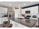 Kitchen featuring white cabinetry, stainless steel appliances, and an eat-in island at 447 Talisi Loop, St Cloud, FL 34771