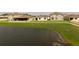 Lush pond-side view of neighborhood homes showcasing tranquil community living at 447 Talisi Loop, St Cloud, FL 34771