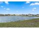 Scenic view of a neighborhood pond surrounded by lush green grass at 447 Talisi Loop, St Cloud, FL 34771