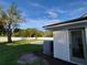 Wide backyard features a fence, trees, shed, and swimming pool under a blue sky at 5153 Lido, Orlando, FL 32807