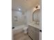 Well-lit bathroom features a tub shower with gold fixtures and an arch-top mirror at 5153 Lido, Orlando, FL 32807