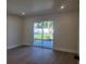 Airy bedroom boasts recessed lighting and sliding glass door to a well-maintained backyard at 5153 Lido, Orlando, FL 32807