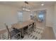 A bright dining room with a wooden table, stylish chairs, and a modern chandelier with views of the living spaces at 5153 Lido, Orlando, FL 32807