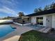 Poolside patio features an outdoor seating area with wicker chairs and a patterned rug at 5153 Lido, Orlando, FL 32807