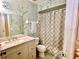 Neutral bathroom featuring sink with vanity, toilet, and shower with patterned shower curtain at 5622 Nokomis Cir, Orlando, FL 32839