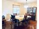 Inviting dining room showcasing hardwood floors, a table set for four, and a decorative chandelier at 5622 Nokomis Cir, Orlando, FL 32839